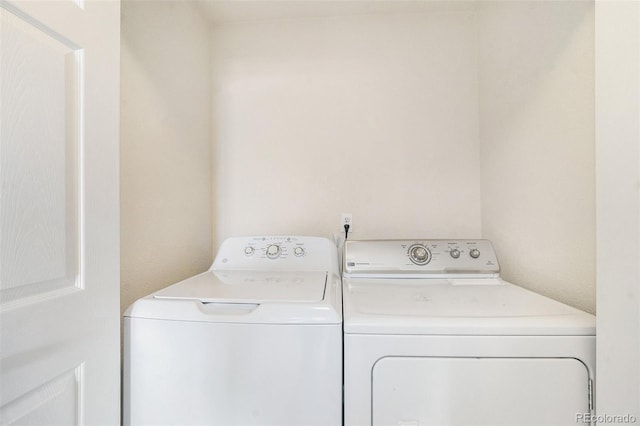 clothes washing area with separate washer and dryer