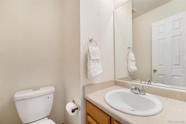 bathroom with toilet and vanity