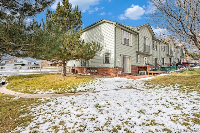 snow covered property with cooling unit