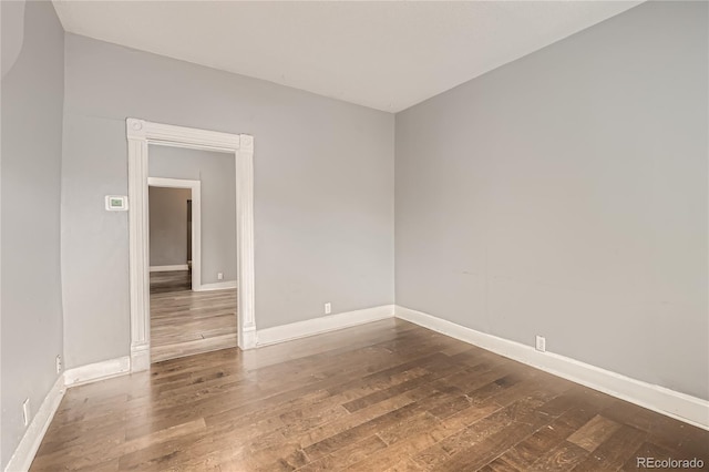 empty room featuring dark hardwood / wood-style flooring