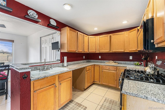 kitchen with recessed lighting, light countertops, light tile patterned flooring, a sink, and black gas stove