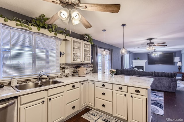 kitchen featuring sink, stainless steel dishwasher, dark hardwood / wood-style floors, kitchen peninsula, and backsplash