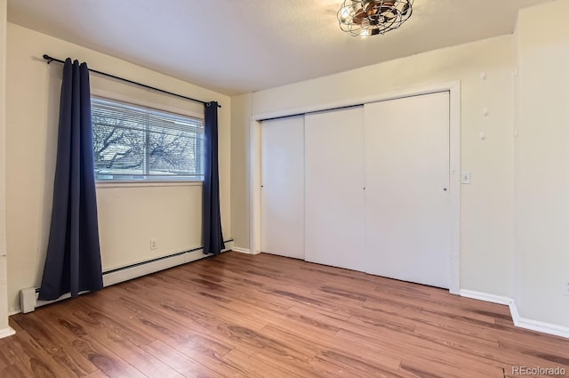 unfurnished bedroom with a closet and light hardwood / wood-style flooring