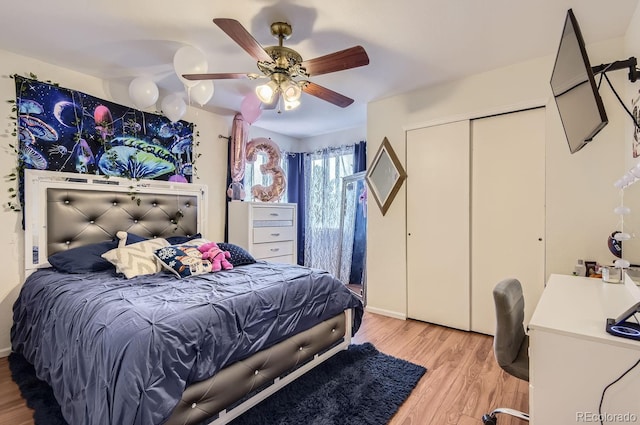 bedroom featuring ceiling fan, light wood-type flooring, and a closet