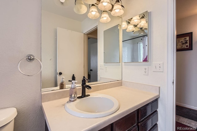 bathroom featuring vanity and toilet