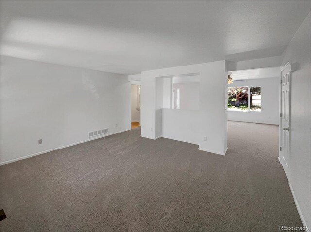 12550 Eastlake Dr, Thornton, CO 80241 - empty room featuring dark colored carpet, baseboards, and ceiling fan
