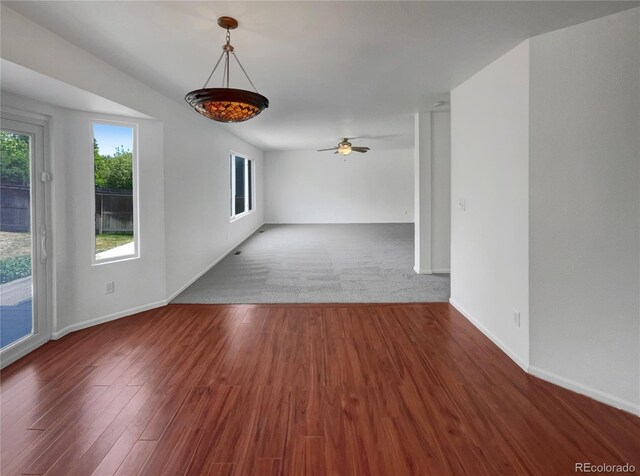 12550 Eastlake Dr, Thornton, CO 80241 - spare room featuring wood finished floors, baseboards, and a ceiling fan