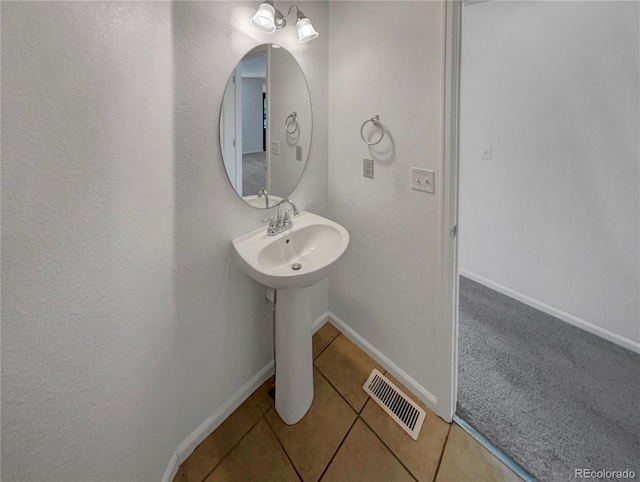 12550 Eastlake Dr, Thornton, CO 80241 - bathroom with tile patterned flooring, baseboards, and a sink