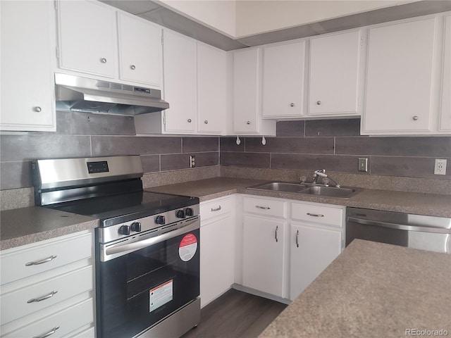 kitchen with tasteful backsplash, white cabinetry, sink, dark hardwood / wood-style flooring, and stainless steel appliances