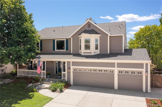 1774 Spring Water Pl, Highlands Ranch, CO 80129 - traditional home featuring concrete driveway, a porch, a shingled roof, and a garage