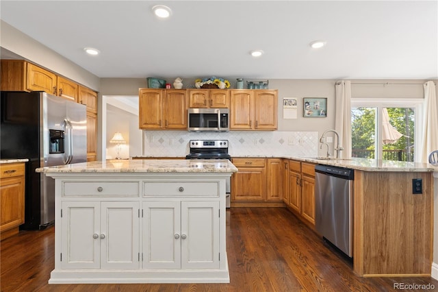1774 Spring Water Pl, Highlands Ranch, CO 80129 - kitchen with stainless steel appliances, light stone countertops, a sink, dark wood-type flooring, and recessed lighting