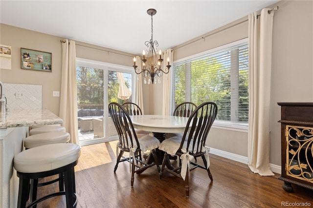 1774 Spring Water Pl, Highlands Ranch, CO 80129 - dining space with a chandelier, dark wood-style flooring, and baseboards
