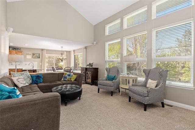 1774 Spring Water Pl, Highlands Ranch, CO 80129 - living room featuring a chandelier, high vaulted ceiling, light colored carpet, and baseboards