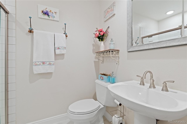 1774 Spring Water Pl, Highlands Ranch, CO 80129 - bathroom with toilet, baseboards, a sink, and tiled shower