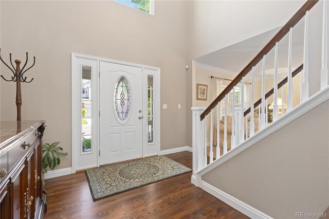 1774 Spring Water Pl, Highlands Ranch, CO 80129 - foyer entrance with baseboards, dark wood-type flooring, stairs, and a towering ceiling