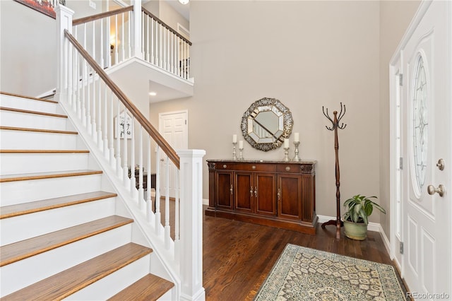 1774 Spring Water Pl, Highlands Ranch, CO 80129 - entrance foyer featuring stairway, dark wood-style flooring, baseboards, and a high ceiling