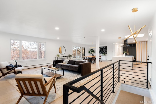 living room featuring light hardwood / wood-style flooring and a baseboard heating unit