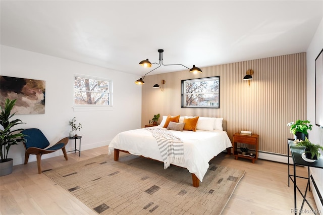 bedroom featuring light hardwood / wood-style flooring and a baseboard radiator