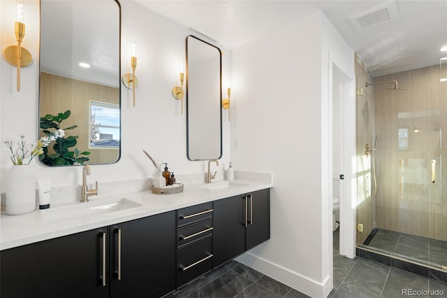 bathroom with an enclosed shower, vanity, toilet, and tile patterned floors