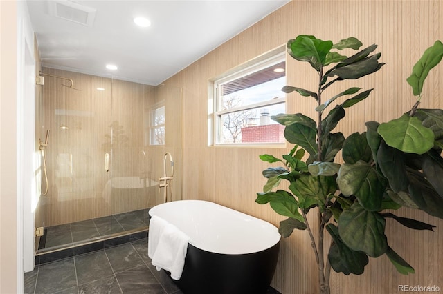 bathroom featuring separate shower and tub