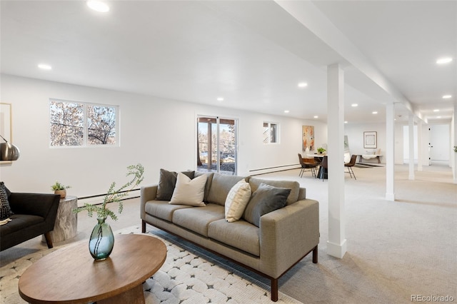 carpeted living room with a baseboard heating unit