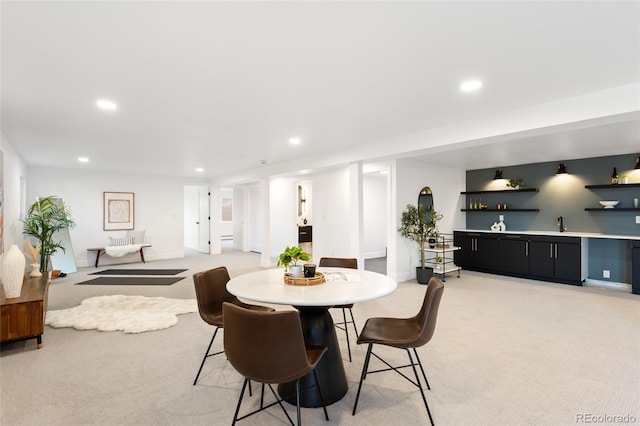 carpeted dining space with indoor bar