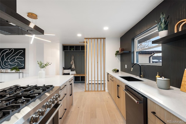 kitchen with light brown cabinets, stainless steel appliances, light hardwood / wood-style flooring, and sink