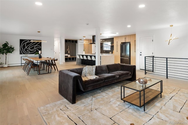 living room with light hardwood / wood-style floors and a baseboard radiator