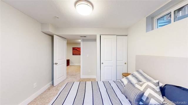 1741 W 55th Pl, Denver, CO 80221 - bedroom featuring light colored carpet, a closet, and a textured ceiling