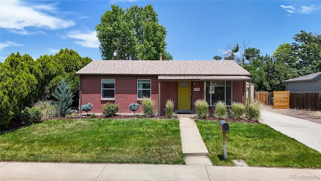 1741 W 55th Pl, Denver, CO 80221 - single story home with brick siding, a porch, and a shingled roof