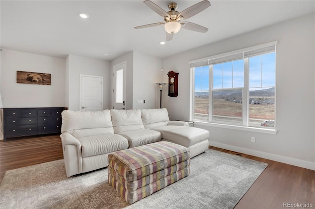 living room with recessed lighting, wood finished floors, a ceiling fan, and baseboards