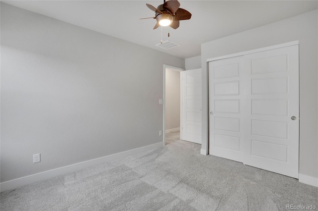 unfurnished bedroom with carpet floors, a closet, visible vents, ceiling fan, and baseboards