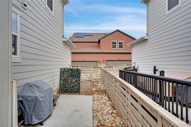 view of patio / terrace featuring a garage, a grill, and a fenced backyard