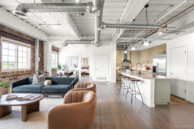 1435 Wazee St Unit 305, Denver, CO 80202 - living area with wood finished floors and brick wall
