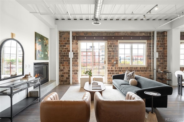 1435 Wazee St Unit 305, Denver, CO 80202 - living room featuring brick wall, wood finished floors, a glass covered fireplace, and healthy amount of natural light