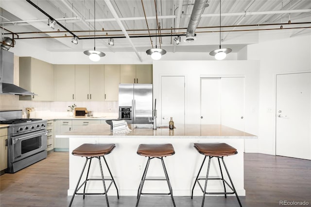 1435 Wazee St Unit 305, Denver, CO 80202 - kitchen with stainless steel appliances, wall chimney exhaust hood, a sink, and wood finished floors