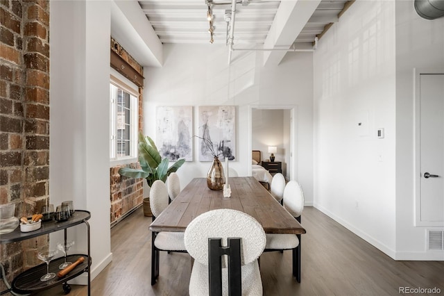 1435 Wazee St Unit 305, Denver, CO 80202 - dining space with wood finished floors, baseboards, and beam ceiling