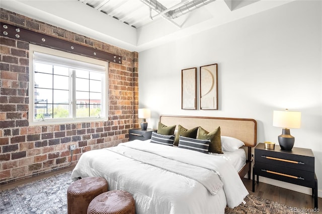 1435 Wazee St Unit 305, Denver, CO 80202 - bedroom featuring brick wall and wood finished floors