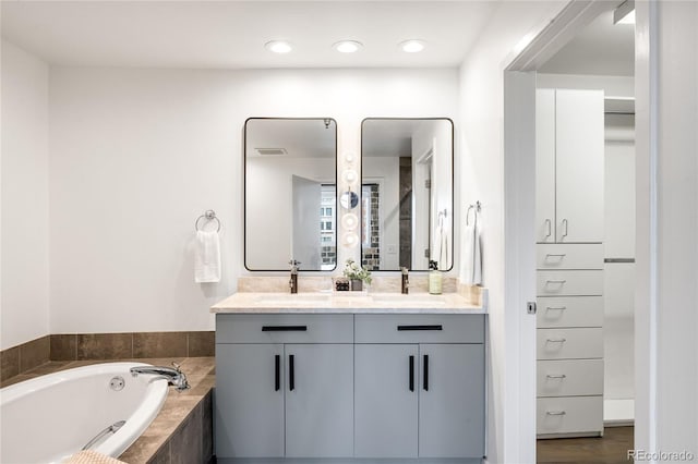1435 Wazee St Unit 305, Denver, CO 80202 - bathroom featuring double vanity, a garden tub, and recessed lighting