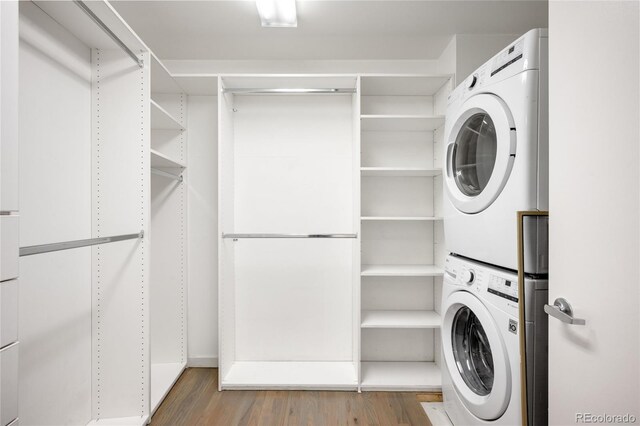 1435 Wazee St Unit 305, Denver, CO 80202 - laundry room featuring stacked washer / dryer and wood finished floors