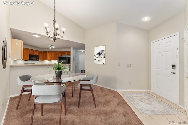 dining space with a notable chandelier and light tile patterned floors