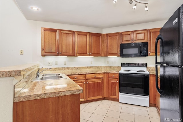 kitchen featuring black appliances, kitchen peninsula, sink, and light tile patterned floors