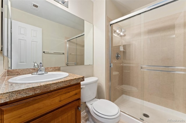 bathroom featuring walk in shower, vanity, and toilet