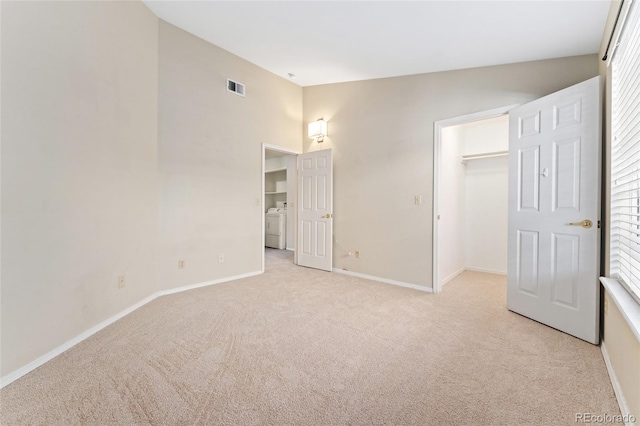 8623 E Dry Creek Rd Unit 423, Englewood, CO 80112 - unfurnished bedroom with washer / clothes dryer, light colored carpet, a spacious closet, and a closet