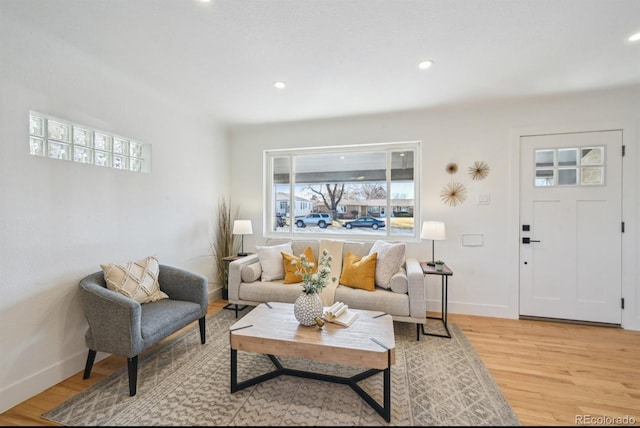 living room featuring light wood-style flooring, recessed lighting, and baseboards