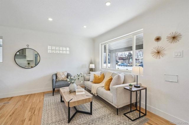 living area featuring recessed lighting, baseboards, and wood finished floors