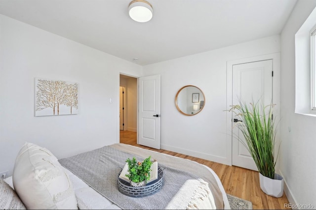 bedroom with baseboards and wood finished floors