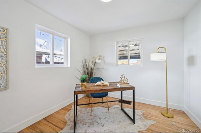 home office featuring wood finished floors and baseboards