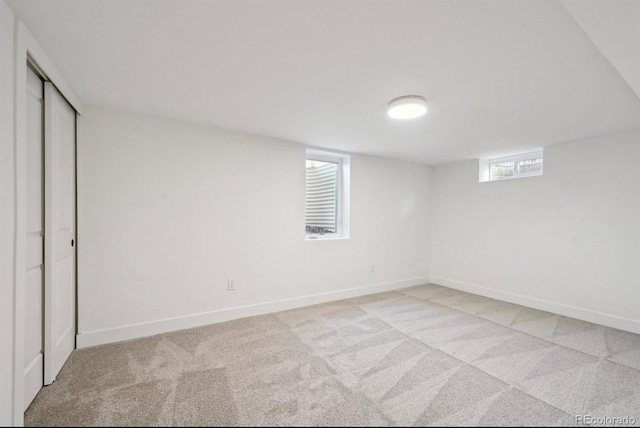 unfurnished bedroom with baseboards and light colored carpet