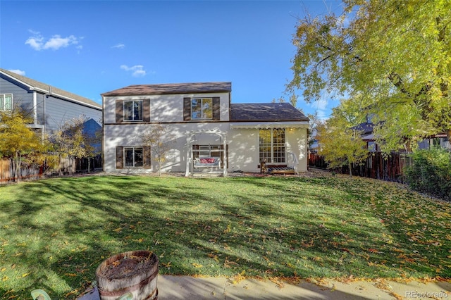 rear view of property featuring a yard